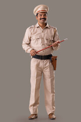 Wall Mural - Portrait of an Indian policeman standing with baton in hand