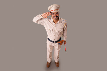 Wall Mural - Top angle view of an Indian policeman saluting