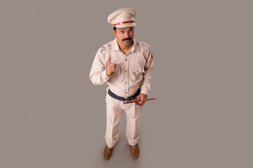 Wall Mural - Top angle view of an Indian policeman warning by pointing with index finger