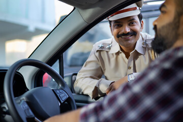 Wall Mural - Portrait of an Indian policeman talking with car driver