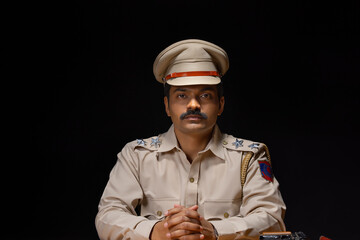 Wall Mural - Portrait of an Indian policeman sitting in policestation