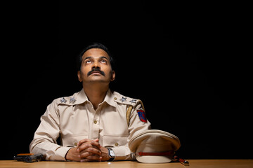 Wall Mural - Portrait of an Indian policeman sitting in policestation