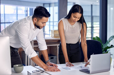Wall Mural - will you approve these documents please. shot of two work colleagues reading over some documents tog