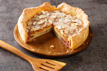 Poster - Bakewell puddings are a traditional dessert made from a pastry base with a layer of jam topped with a filling of egg and almond paste closeup on the table. Horizontal