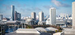 東京の有明のパノラマ風景。高層ビルと電車の駅と青空。