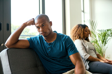 Canvas Print - How did our relationship become this complicated. Shot of a young man looking upset after having a fight with his partner at home.