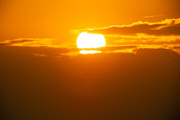 Wall Mural - Telephoto lens Close up the sun in sunset Dramatic sky time-lapse 4k. Clouds and Sun Rising Sky Time Lapse. Closeup Telephoto Lens. Travel, Beginning, Nature Concept. Location: Southern of Thailand.
