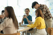 © Natee Meepian - Young asian woman wokring in board room with her team to discussing idea fro startup project