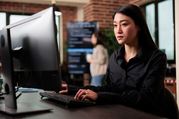 Cyber officer working with binary numbers for database application development through neural nodes. Asian software developer engineering security algorithm using visual programming.