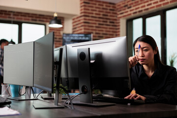 meditative asian program engineer thinking of ways to combat hacking attacks. thoughtful blockchain 