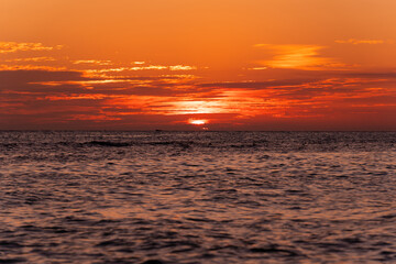 Wall Mural - Beautiful view of the sea and the sky in the clouds at sunset. Orange red dawn, dusk on the sea coast