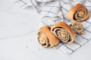 Wall Mural - Homemade poppy seed roll buns on a white table