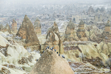 Wall Mural - Fairy tale chimneys in Cappadocia with blue sky on background in Goreme,Nevsehir, Turkey. Volcanic rock landscape, Stone houses. 