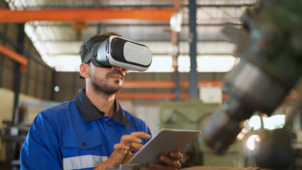 Engineer wearing virtual reality headset standing in the manufacturing factory. Moving hand and looking around the data. Working with Holographic Animations. High technology and industrial concept