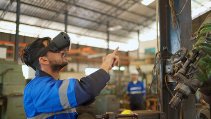 Engineer wearing virtual reality headset standing in the manufacturing factory. Moving hand and looking around the data. Working with Holographic Animations. High technology and industrial concept