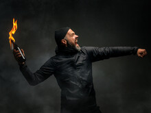 Emotional Portrait Of A Man With A Molotov Cocktail In His Hands. A Man Throws A Molotov Cocktail. The Concept Of Protest And Resistance