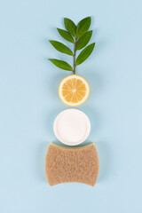 Wall Mural - Natural household cleaners - baking soda, lemon, citric acid on blue background with copy space. Bio organic detergent products, home cleaning and washing concept. Green household. Vertical image