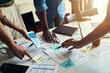 © Tamani C/peopleimages.com - Around the meeting table. High angle shot of a group of unrecognizable businesspeople looking over some paperwork in the boardroom.