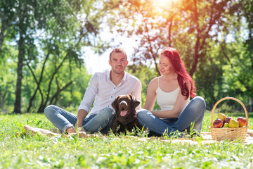 Wall Mural - Couple with a dog in the park