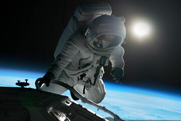 Wall Mural - female astronaut performing spacewalk, working on a outer part of a space craft