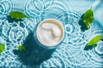 Sticker - beauty cream and green leaves on clear water