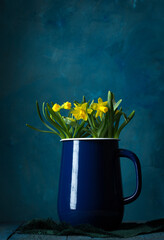 Wall Mural - Beautiful yellow daffodils in a blue jug