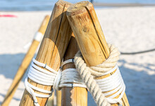 Close-up, Wooden Posts On The Sandy Beach.