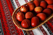 Easter eggs decorated with flower print in a basket on Ukrainian rushnyk