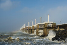 Netherlands, Vrouwenpolder, Sea Waves Crashing Against Pier During Storm Eunice
