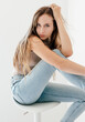 © Connect Images - Studio portrait of blonde woman in skinny jeans