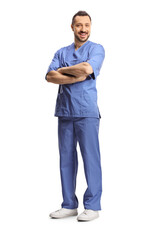 Wall Mural - Full length shot of a young male healthcare worker in a blue uniform posing with crossed arms