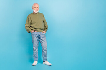 Sticker - Full length body size view of attractive cheerful grey-haired man holding hands in pockets isolated over vivid blue color background