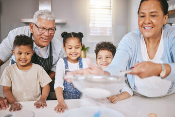 Wall Mural - Learning family secrets. Shot of a mature couple baking with their grandkids at home.