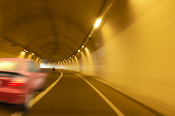 Wall Mural - red car moving through a tunnel