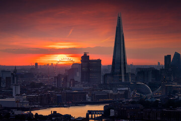  Elevated view of the modern skyline of London, United Kingdom, with many popular tourist attractions during a fiery sunset