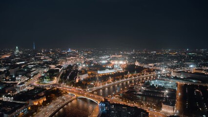 Wall Mural - Beautiful aerial panorama of Moscow Kremlin at night. View from above to the towers of Kremlin, Moskva River and Kremlevskaya Naberezhnaya with evening lights and busy traffic in motion timelapse.