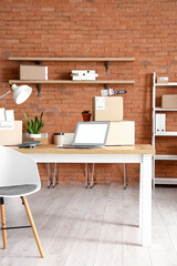 Wall Mural - Cardboard boxes with belongings and furniture in interior of office on moving day