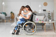 canvas print picture Little girl and her mother in wheelchair on International Women's Day at home