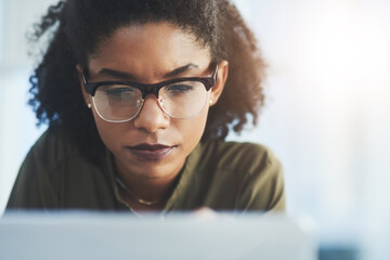 Poster - Persistence and hard work are always key in success. Shot of a young businesswoman busy working on her laptop in a modern office.