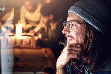 Poster - Looking at the big picture. Cropped shot of a designer working on his computer on a night shift at work.