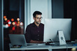 © Daniel Laflor/peopleimages.com - Staying late to get it done. Shot of a young businessman using a computer at his desk during a late night at work.