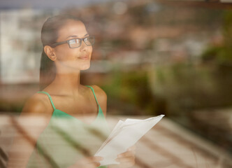 Wall Mural - Looking out for opportunities on the horizon. A cropped shot of a young woman holding a document indoors.