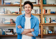 © Arnéll Koegelenberg/peopleimages.com - Hes a self-professed bibliophile. Shot of a happy bachelor posing with his arms crossed in front of a bookshelf at home.