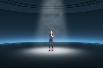 Thoughtful young businesswoman standing in abstract dark round pedestal interior with spotlight.
