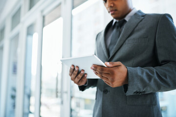 Aufkleber - Who has time to be tied to their desk. Shot of a businessman using a digital tablet in a modern office.