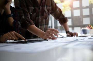 Wall Mural - team of web application developer working on new project together at creative office.