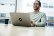 © Jacob Lund - Cheerful businessman laughing happily in a co-working space