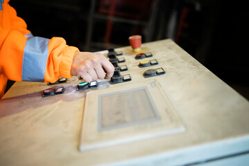 Wall Mural - Industrial worker operating factory control panel.