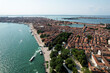Aerial view of the beautiful cityscape of Venice, Italy surrounded by a vast ocean