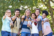 We give this college our stamp of approval. Portrait of a group of students smiling for the camera with their thumbs up.